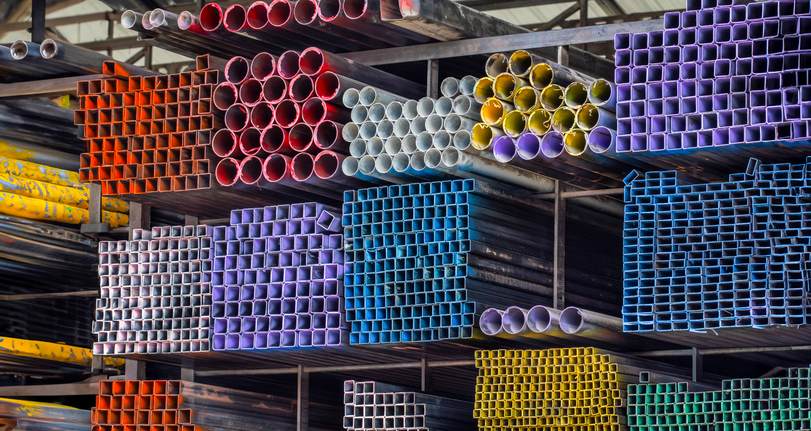 Stacks of round steel pipes are stored in an industrial warehouse in Philadelphia, PA